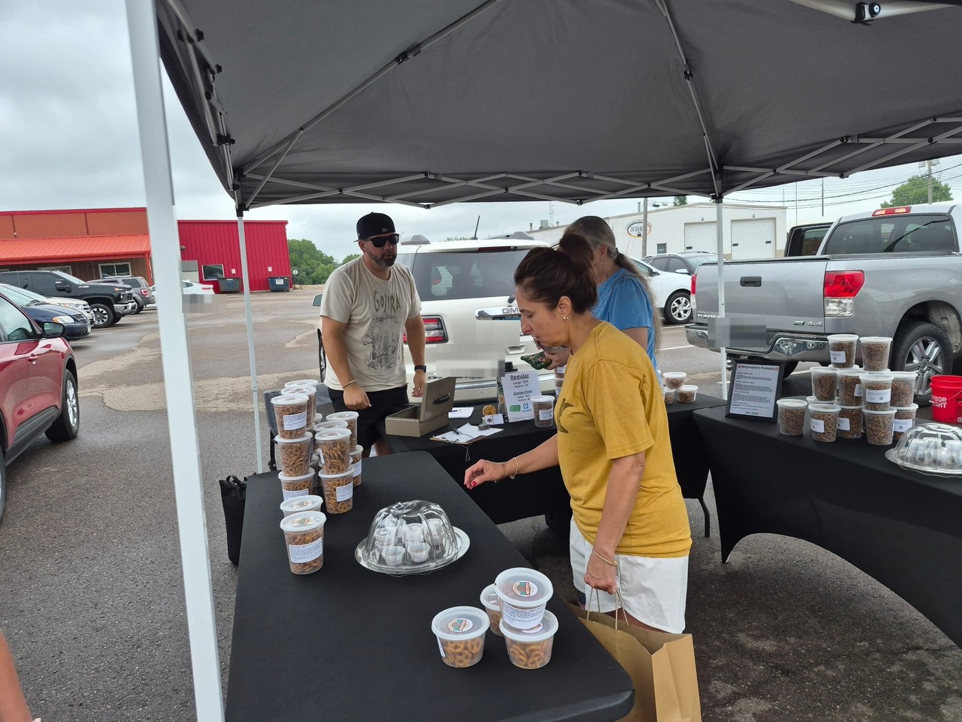 Customers visiting the Weymann’s Pretzels booth at a local market