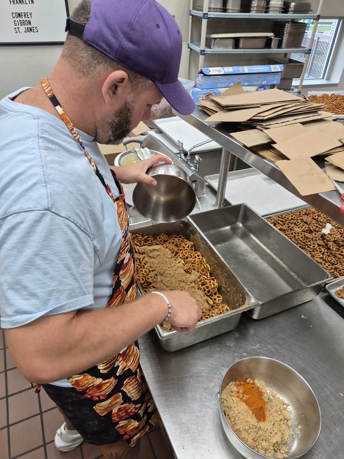 Chris Weymann adding seasoning to a batch of Weymann’s Pretzels